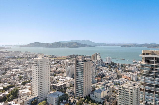 property's view of city with a water and mountain view