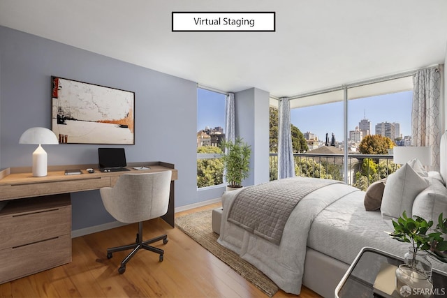 bedroom featuring built in desk and light wood-type flooring