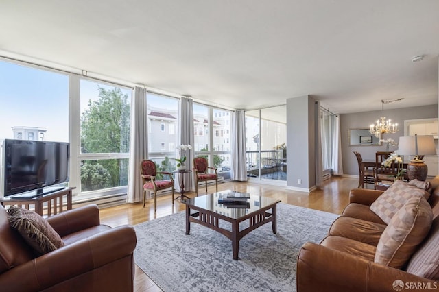 living room with a wealth of natural light, light hardwood / wood-style floors, and floor to ceiling windows