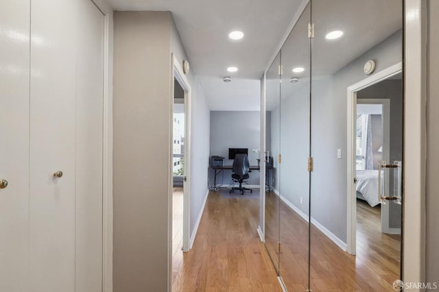 hall with light hardwood / wood-style flooring