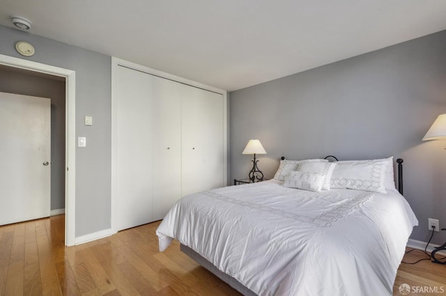 bedroom featuring a closet and light wood-type flooring