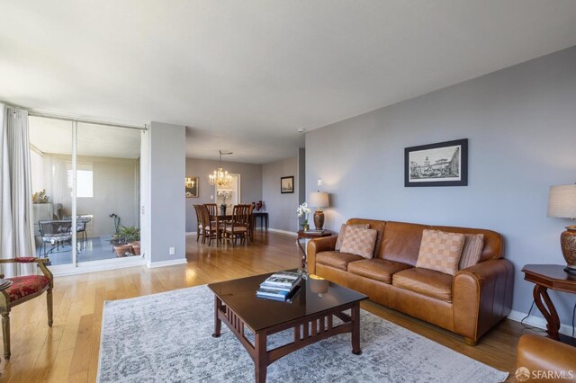 living room with an inviting chandelier and light hardwood / wood-style floors