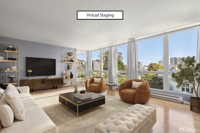 living room featuring wood-type flooring, a wall of windows, and baseboard heating