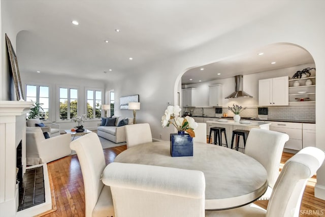 224 Twin Peaks Blvd, San Francisco, CA 94114 - dining space with arched walkways, light wood finished floors, and recessed lighting