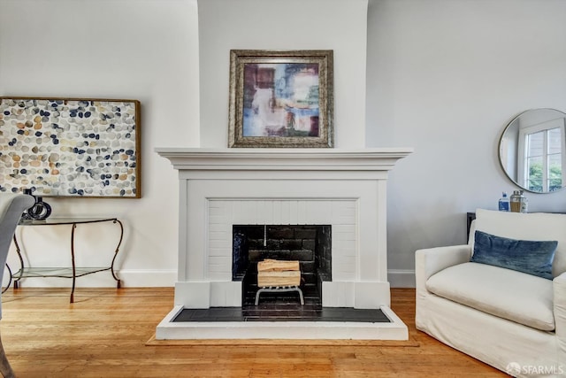 224 Twin Peaks Blvd, San Francisco, CA 94114 - living room featuring wood finished floors and a fireplace with raised hearth