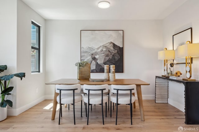 dining space with light wood-type flooring