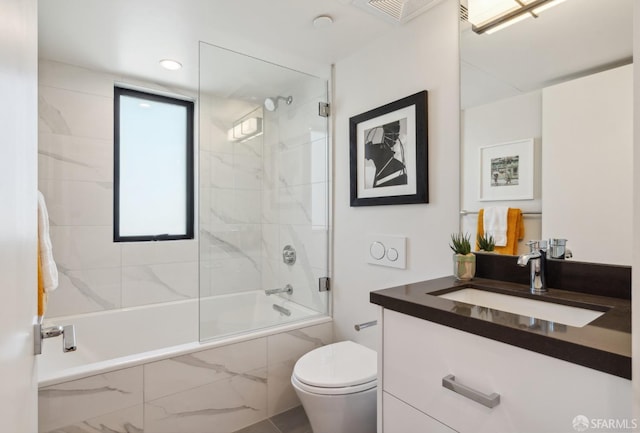 full bathroom featuring toilet, tiled shower / bath combo, and vanity