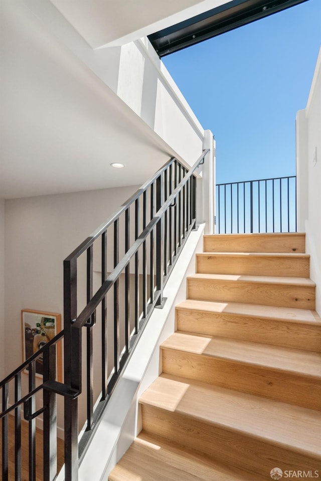 staircase featuring hardwood / wood-style floors