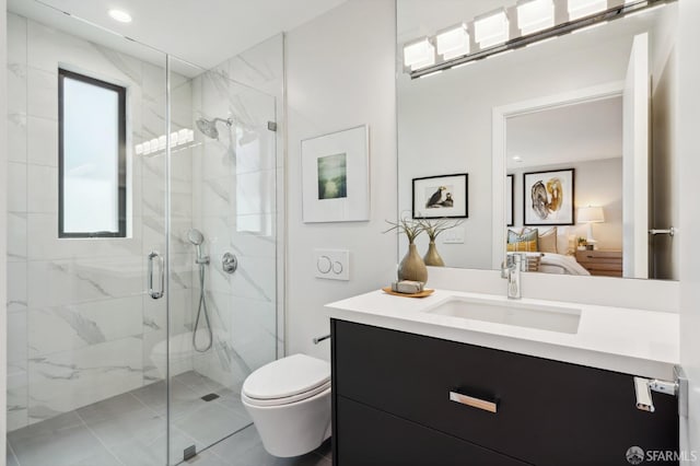 bathroom with a shower with shower door, vanity, toilet, and tile patterned flooring