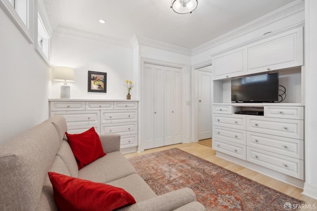 living room featuring ornamental molding and light wood-type flooring