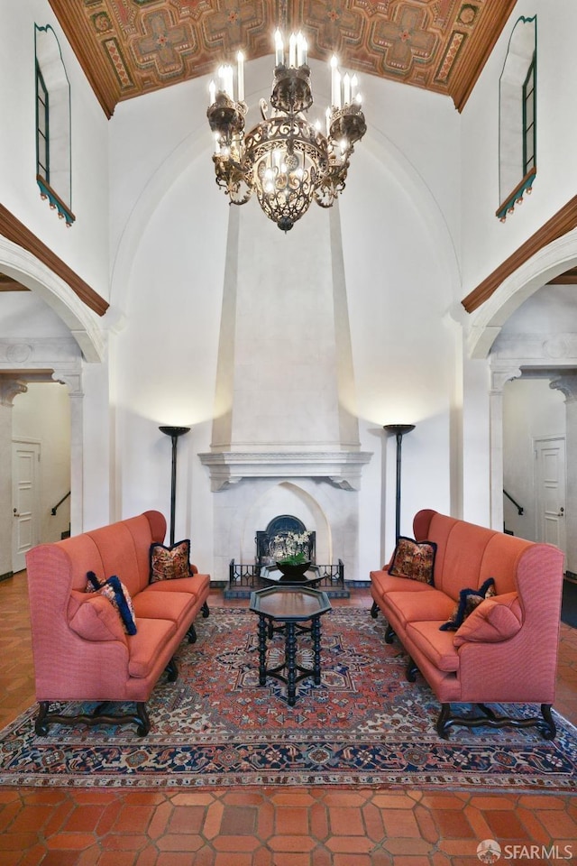 living room featuring a high end fireplace and a high ceiling