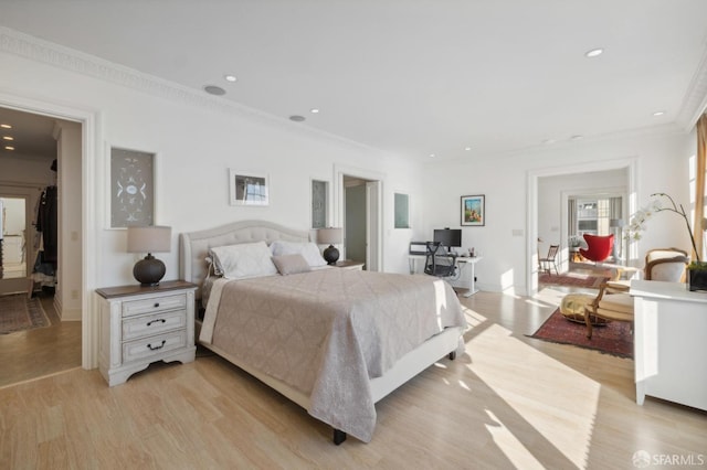 bedroom with light hardwood / wood-style flooring and ornamental molding