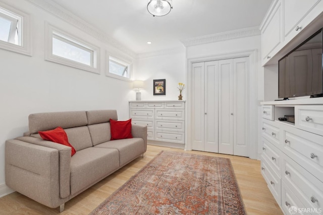 living room featuring ornamental molding and light hardwood / wood-style floors