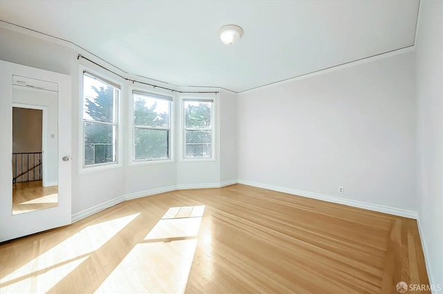 empty room featuring light wood-style flooring and baseboards