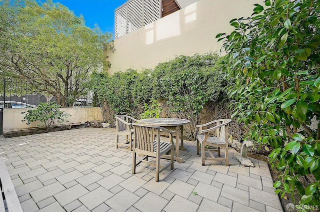 view of patio / terrace featuring outdoor dining area and fence