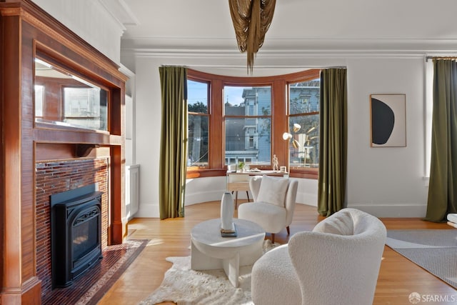 living area featuring crown molding and light wood-type flooring