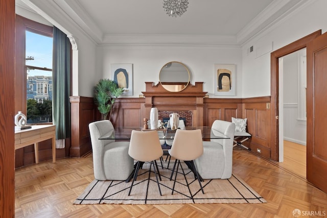 dining space featuring light parquet floors and ornamental molding