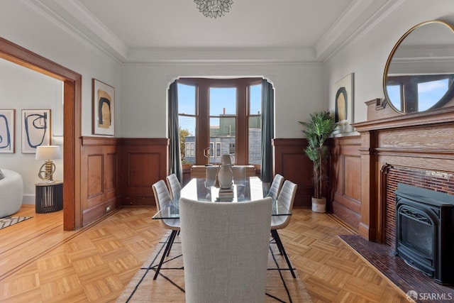 dining area with crown molding and light parquet flooring