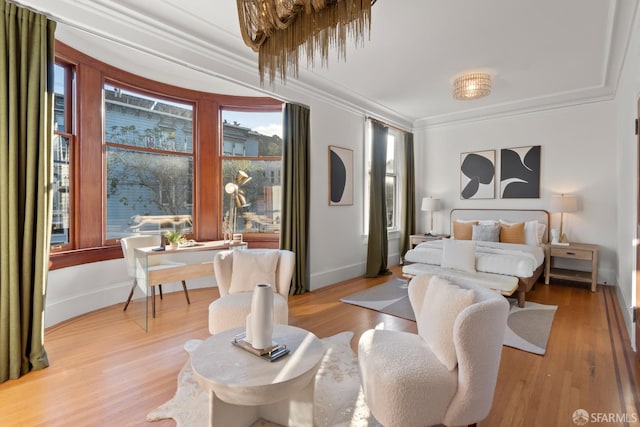 bedroom featuring crown molding and light hardwood / wood-style floors