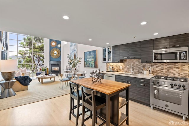 1207 Indiana St Unit 10, San Francisco, CA 94107 - kitchen featuring stainless steel appliances, light countertops, a sink, tasteful backsplash, and open floor plan