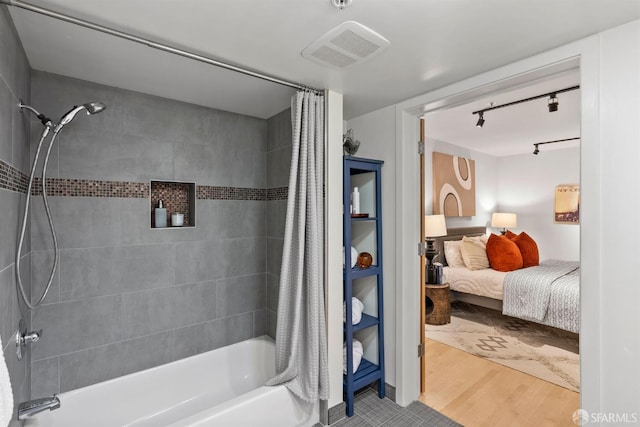 1207 Indiana St Unit 10, San Francisco, CA 94107 - ensuite bathroom featuring wood finished floors, rail lighting, visible vents, shower / tub combo with curtain, and ensuite bath