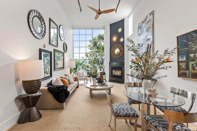 1207 Indiana St Unit 10, San Francisco, CA 94107 - living room with carpet flooring, baseboards, a towering ceiling, a large fireplace, and ceiling fan