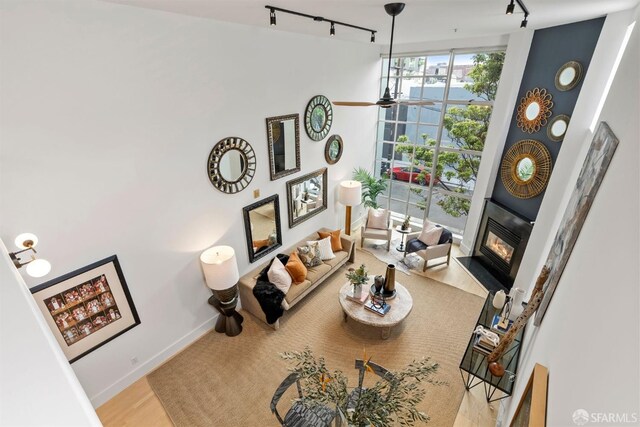 1207 Indiana St Unit 10, San Francisco, CA 94107 - living room featuring a water view, baseboards, a glass covered fireplace, a ceiling fan, and track lighting