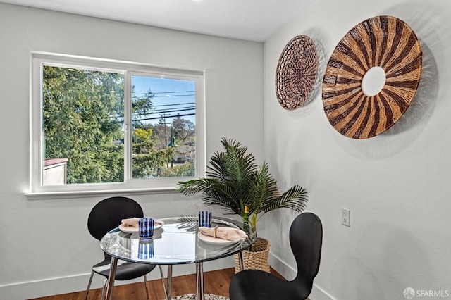 dining space with a wealth of natural light and wood-type flooring