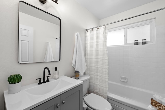 full bathroom featuring vanity, shower / bath combination with curtain, and toilet