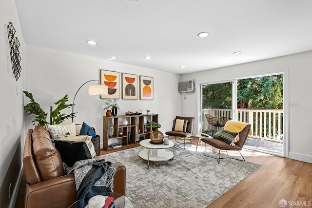 living room featuring wood-type flooring and a wall mounted AC