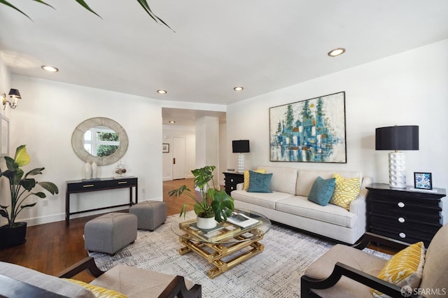 living room with recessed lighting, baseboards, and wood finished floors