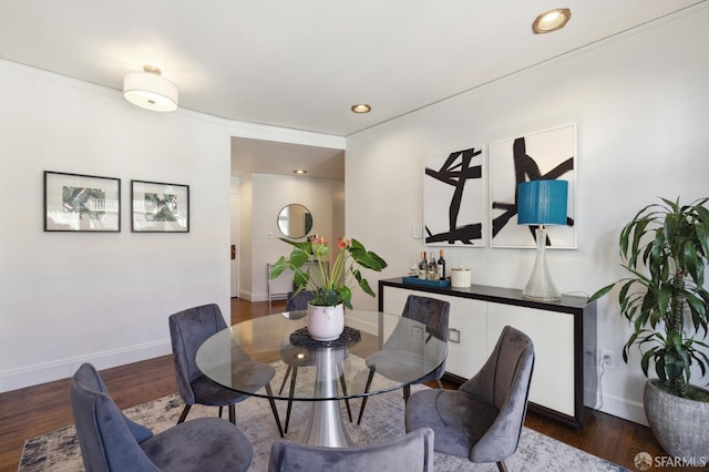 dining area with ornamental molding, dark wood finished floors, and baseboards