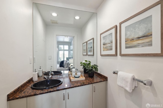 bathroom with vanity, visible vents, and recessed lighting