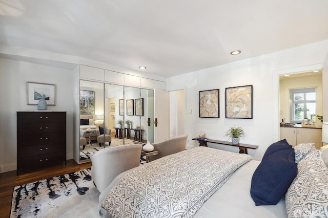 bedroom with baseboards, a closet, wood finished floors, and recessed lighting