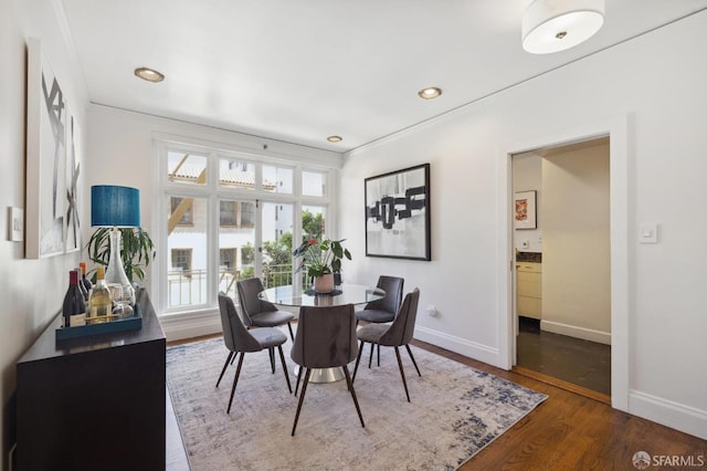 dining space with recessed lighting, wood finished floors, and baseboards