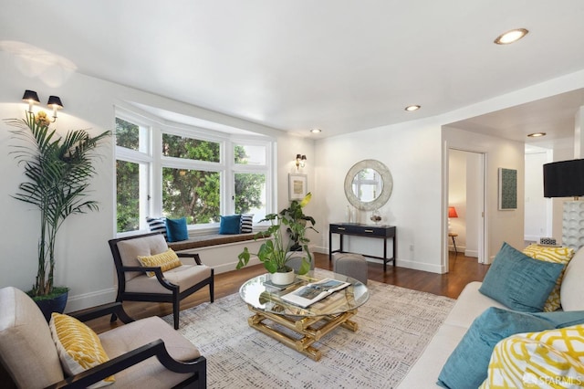 living room featuring recessed lighting, baseboards, and wood finished floors