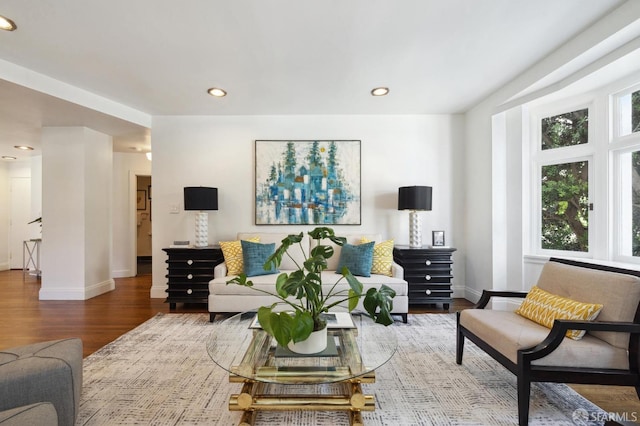 living area with recessed lighting, baseboards, and wood finished floors