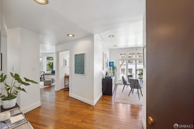 hall with recessed lighting, baseboards, and wood finished floors