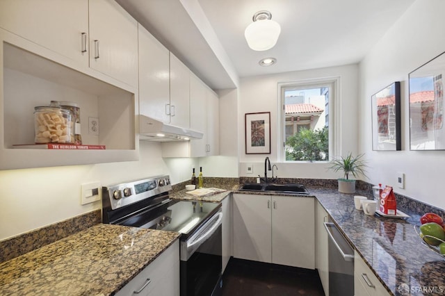 kitchen featuring stainless steel appliances, white cabinetry, a sink, dark stone counters, and under cabinet range hood