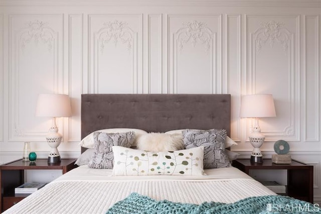 bedroom featuring a decorative wall