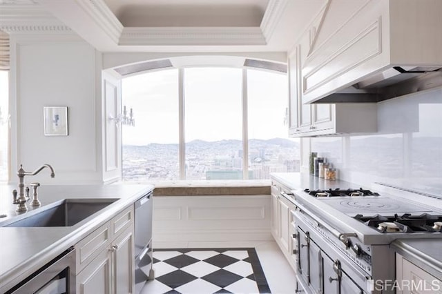 kitchen with a sink, custom range hood, white cooktop, dishwasher, and light floors