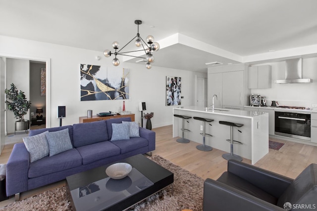1545 Pine St Unit 1201, San Francisco, CA 94109 - living room with light wood-type flooring and a chandelier