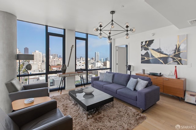 1545 Pine St Unit 1201, San Francisco, CA 94109 - living area featuring a view of skyline, a chandelier, and light wood-type flooring