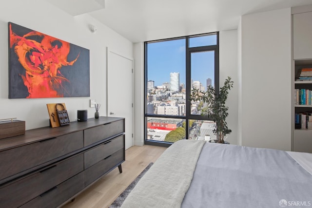 1545 Pine St Unit 1201, San Francisco, CA 94109 - bedroom featuring a wall of windows, light wood-type flooring, and a view of skyline
