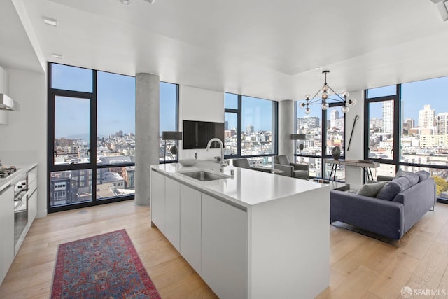 1545 Pine St Unit 1201, San Francisco, CA 94109 - kitchen with modern cabinets, floor to ceiling windows, white cabinetry, and light wood-style flooring