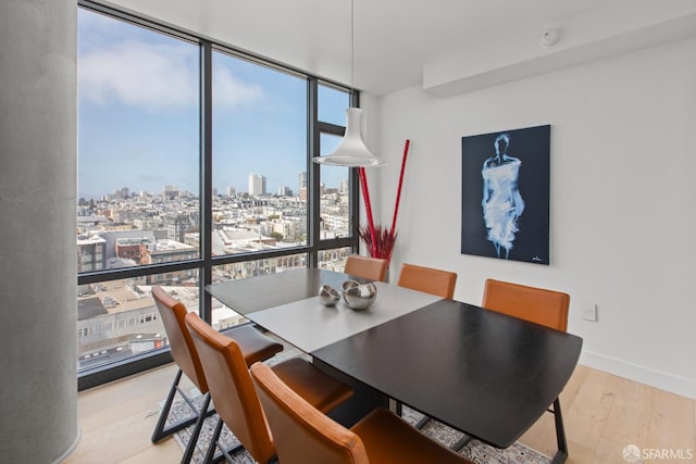 1545 Pine St Unit 1201, San Francisco, CA 94109 - dining room featuring expansive windows, healthy amount of natural light, wood finished floors, and a view of city