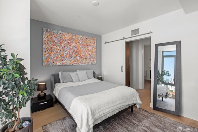 1545 Pine St Unit 1201, San Francisco, CA 94109 - bedroom with wood finished floors and a barn door