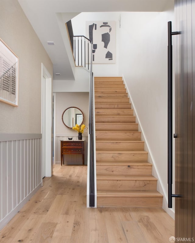 stairway with hardwood / wood-style flooring