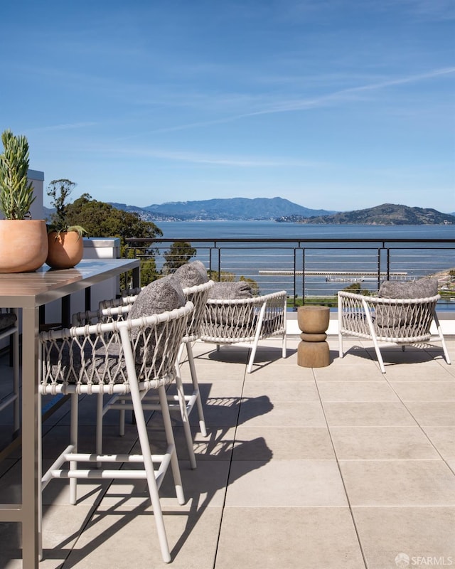 view of patio / terrace featuring a balcony and a water and mountain view