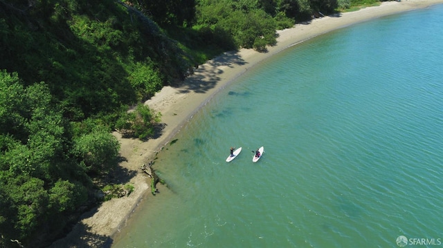 aerial view with a water view and a beach view